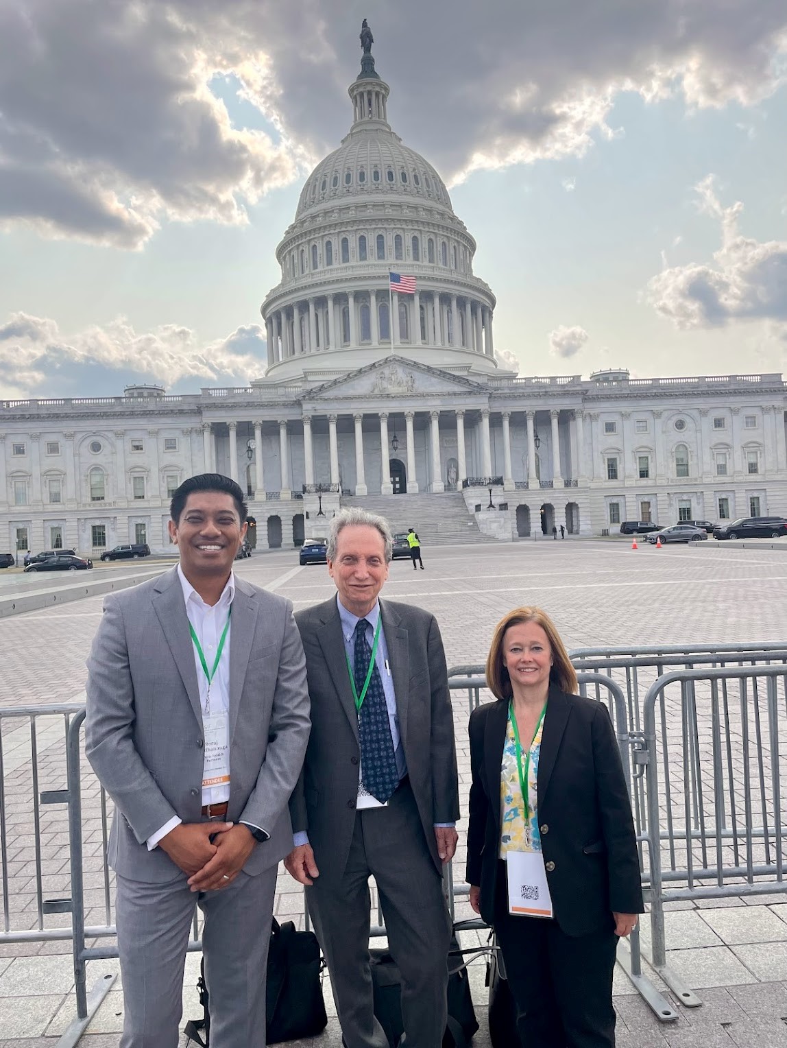 Veris Chief Investment Officer Roraj Pradhananga, Co-Founder Michael Lent, and Director of Client Service Karen deRochemont stand in front of the U.S. Capitol Building in Washington D.C.
